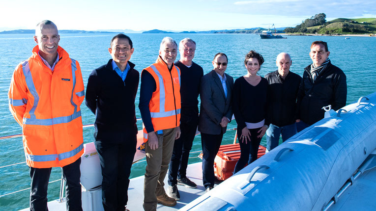 Team members in New Zealand by the water