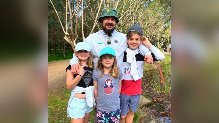 Jason McCallum outdoors with his three children