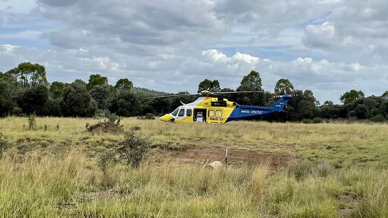 A helicopter taking off from a bushland environment