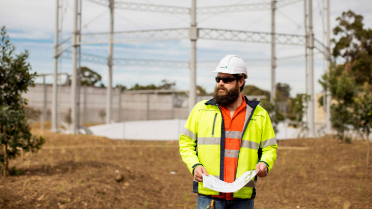 Individual in Ventia branded high-visibility attire at the Macdonaldtown project site.