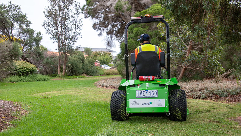 Ventia employee mowing a lawn